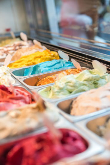 a selection of ice creams viewed from behind a counter